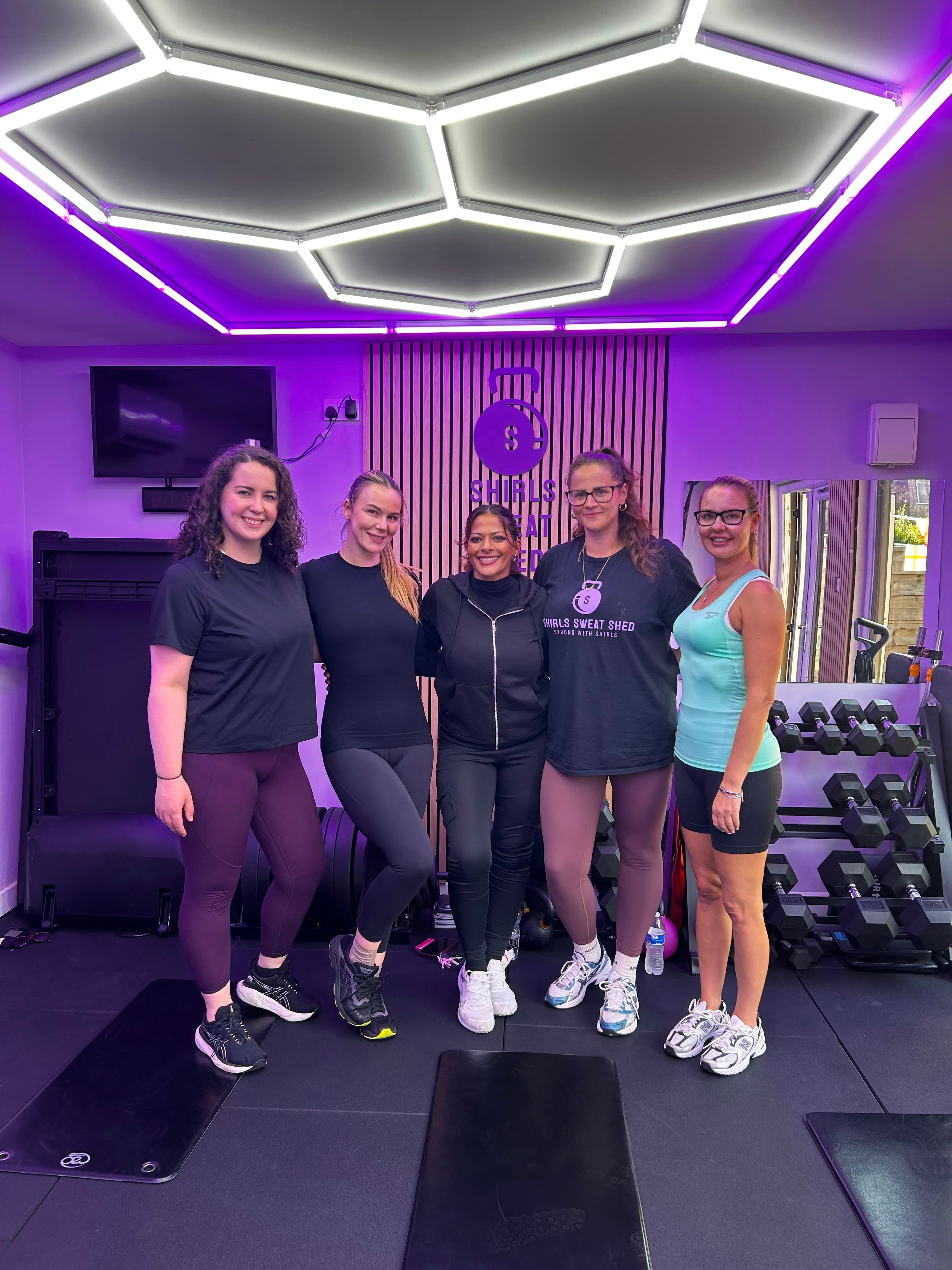 The Shirls Sweat Shed coaching team in matching tees